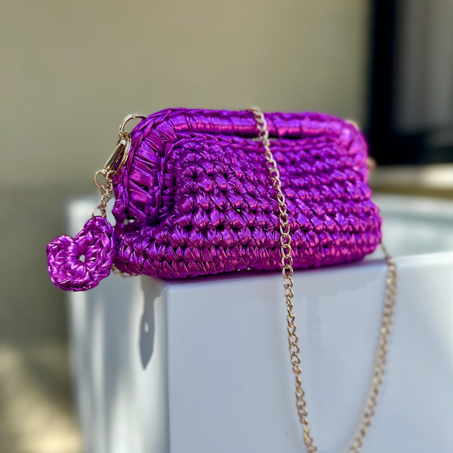 Borsa realizzata all'uncinetto in ecopelle magenta con chiusura a molla e dettagli color oro